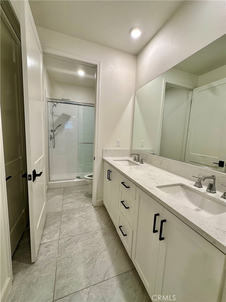 12358 Primrose Avenue Whittier, CA 90602 - Photo 30 of 50 a spacious bathroom with a double vanity sink mirror and shower