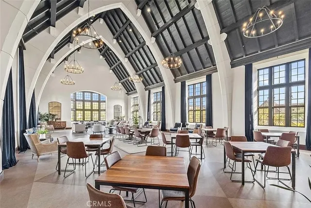 a view of a dining room with furniture a chandelier and wooden floor