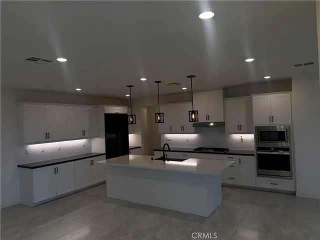 a living room with furniture and a kitchen view