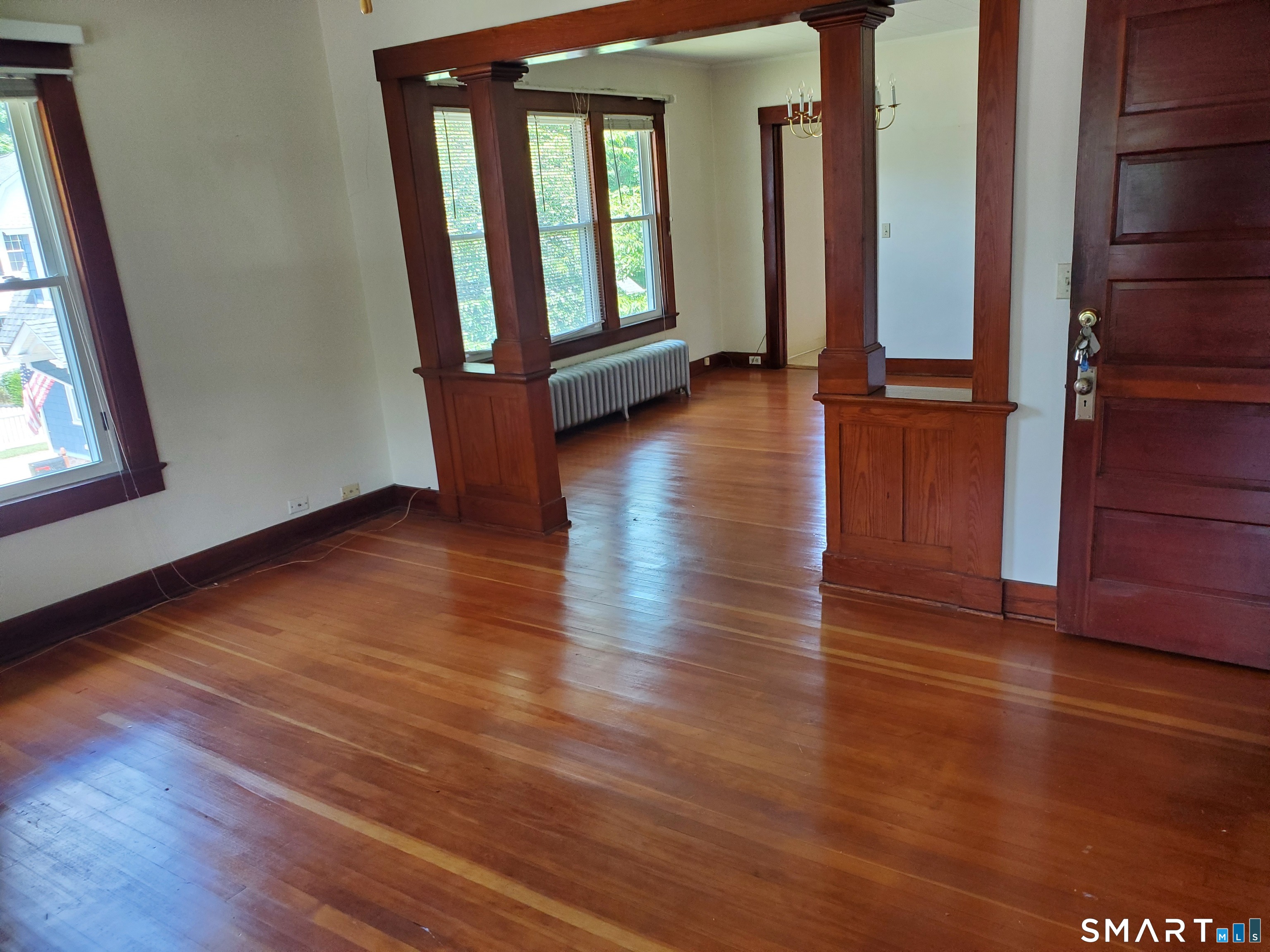 79 Heminway Park Road, Unit 2 Watertown, CT 06795 - Photo 3 of 15 an empty room with wooden floor and windows