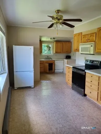 a kitchen with a sink cabinets and a window