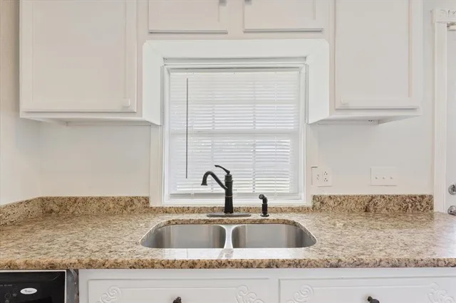 a kitchen with granite countertop a sink and a granite counter tops