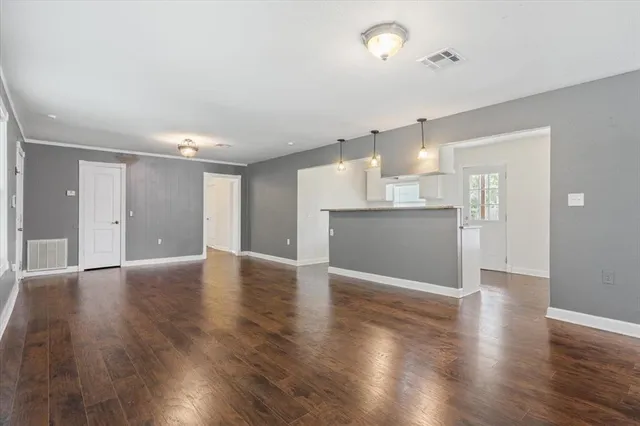a view of a kitchen with a sink and a refrigerator