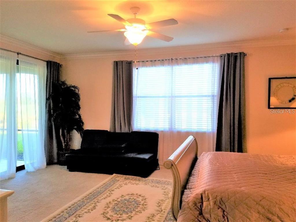 5844 Wake Forest Run, Unit 101 Lakewood Ranch, FL 34211 - Photo 12 of 16 a bedroom with bed and window