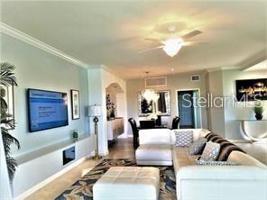 5844 Wake Forest Run, Unit 101 Lakewood Ranch, FL 34211 - Photo 4 of 16 a living room with furniture and a flat screen tv