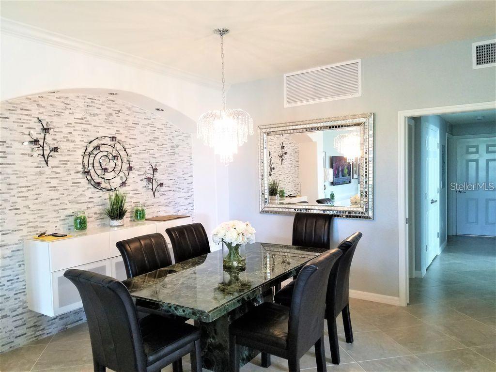 5844 Wake Forest Run, Unit 101 Lakewood Ranch, FL 34211 - Photo 7 of 16 a view of a dining room with furniture and window
