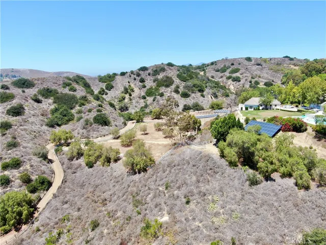 an aerial view of a house with a yard