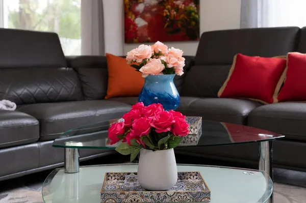 a living room with furniture flowerpot and a window