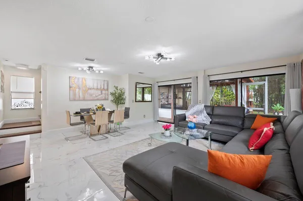 a living room with furniture and wooden floor
