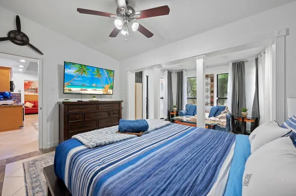 a bedroom with a bed and a flat screen tv