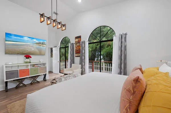 a bed room with a bed mirror and a window