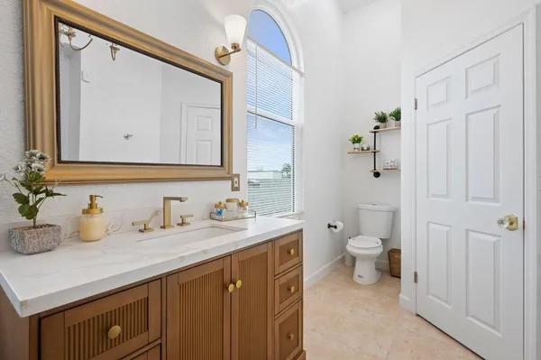 a bathroom with a granite countertop sink and a mirror