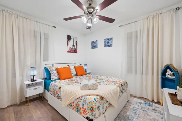 a bedroom with a large bed and a chandelier