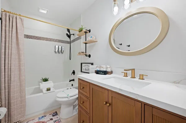 a bathroom with a toilet a sink and a mirror