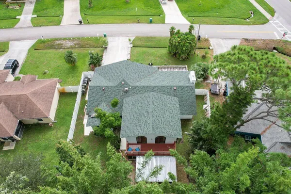an aerial view of a house with a garden and trees