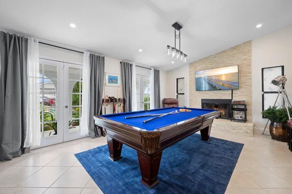 a room with pool table and windows