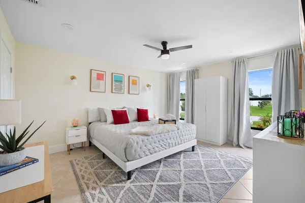 a bedroom with a large bed and a chandelier