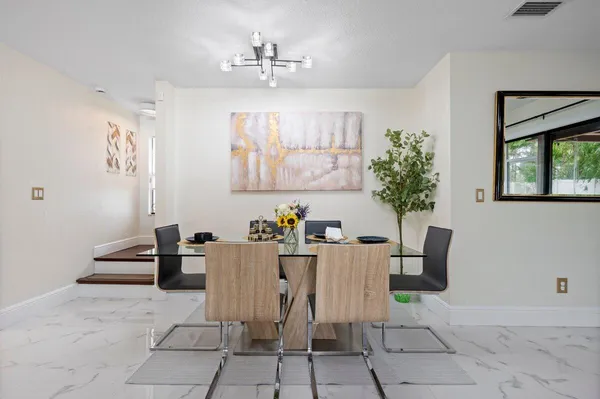 a view of a dining room with furniture and window