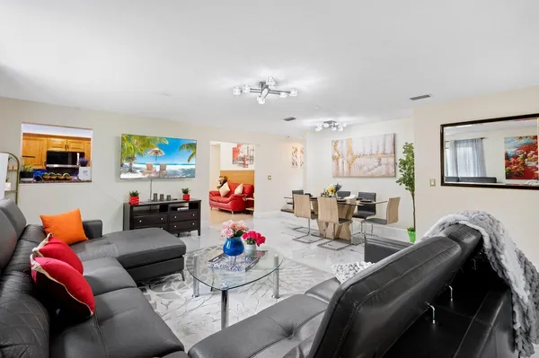 a living room with furniture and painting on the wall