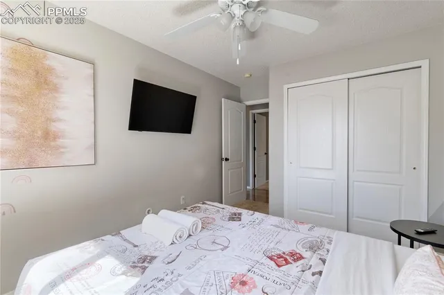 a bedroom with a bed and a flat screen tv