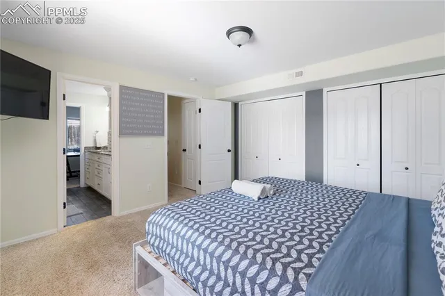 a bedroom with a bed and a flat screen tv