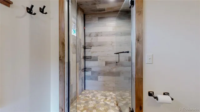 a bathroom with a glass shower door