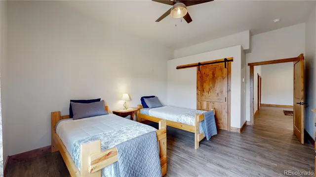 a bedroom with two beds and painted walls