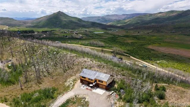 an aerial view of a house with a yard