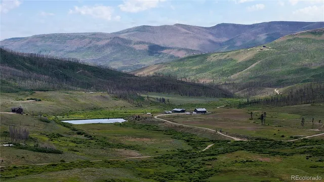 a view of a lush green hillside and houses