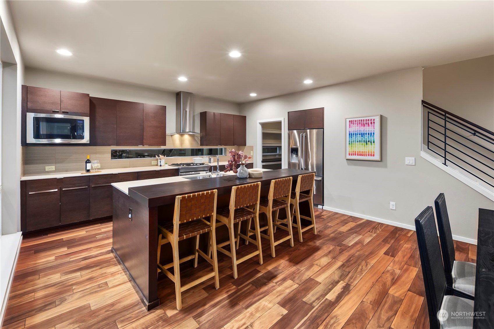 4108 171st Street Southeast Bothell, WA 98012 - Photo 4 of 40 a kitchen with stainless steel appliances granite countertop a stove a sink a microwave a center island and a refrigerator