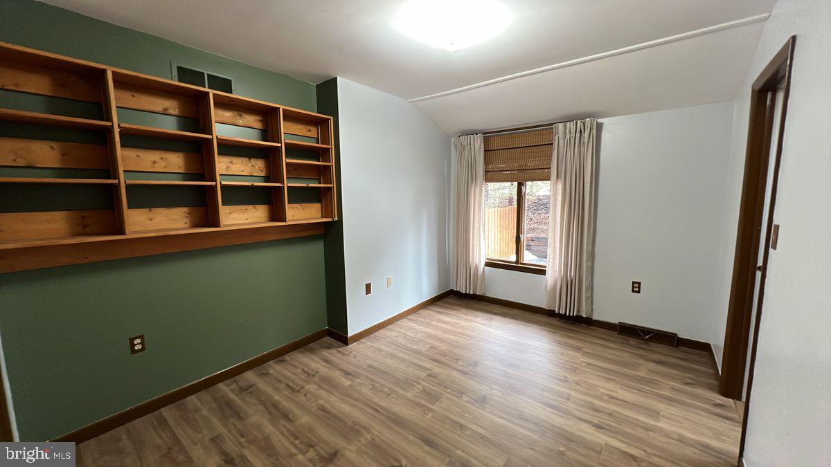 6728 Hemlock Point Road New Market, MD 21774 - Photo 12 of 28 a view of empty room with wooden floor and fan