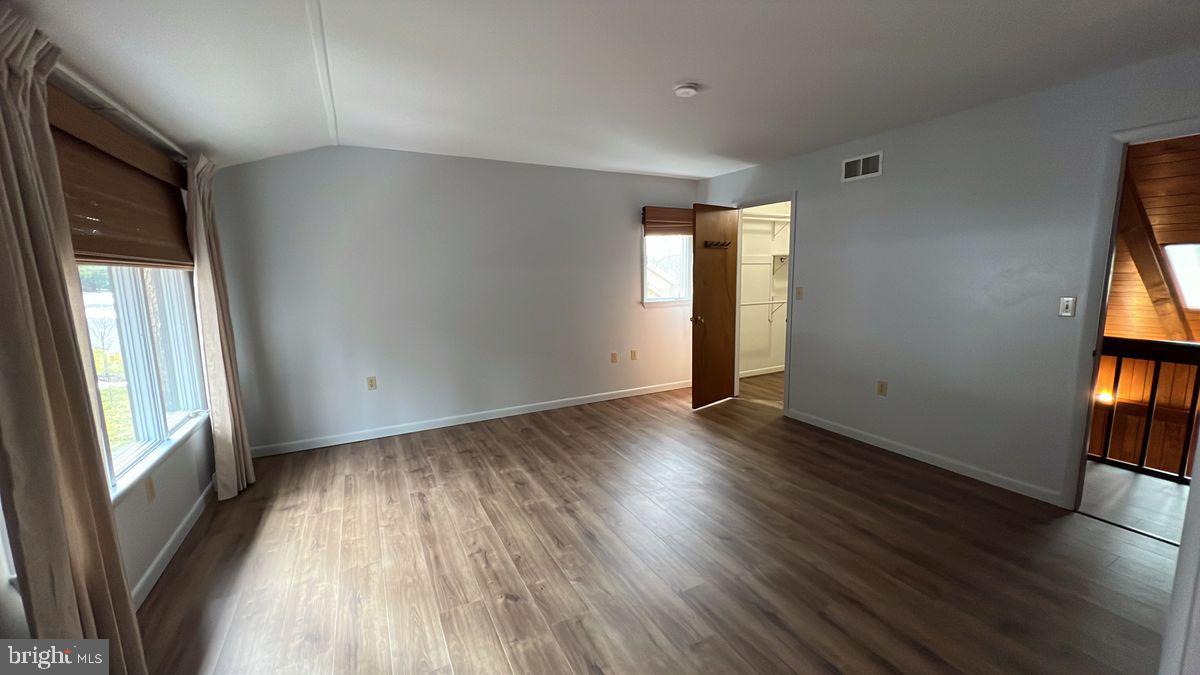 6728 Hemlock Point Road New Market, MD 21774 - Photo 15 of 28 wooden floor in an empty room with a window