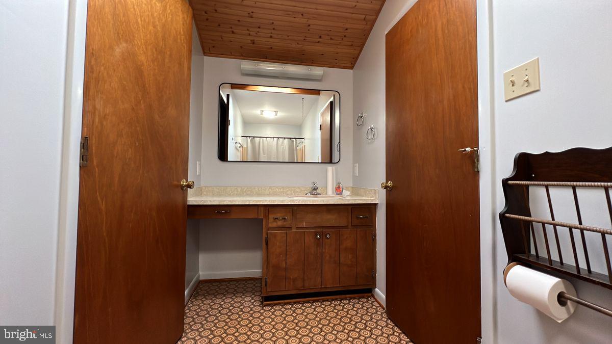 6728 Hemlock Point Road New Market, MD 21774 - Photo 17 of 28 a bathroom with a sink and a mirror