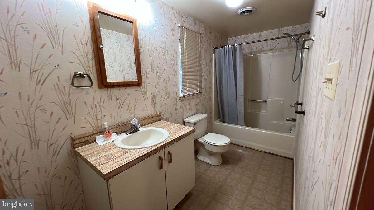 6728 Hemlock Point Road New Market, MD 21774 - Photo 23 of 28 a bathroom with a granite countertop sink toilet and shower