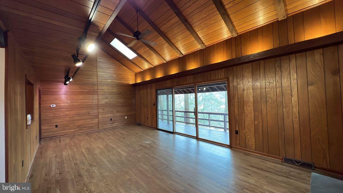 6728 Hemlock Point Road New Market, MD 21774 - Photo 3 of 28 an empty room with wooden floor and windows