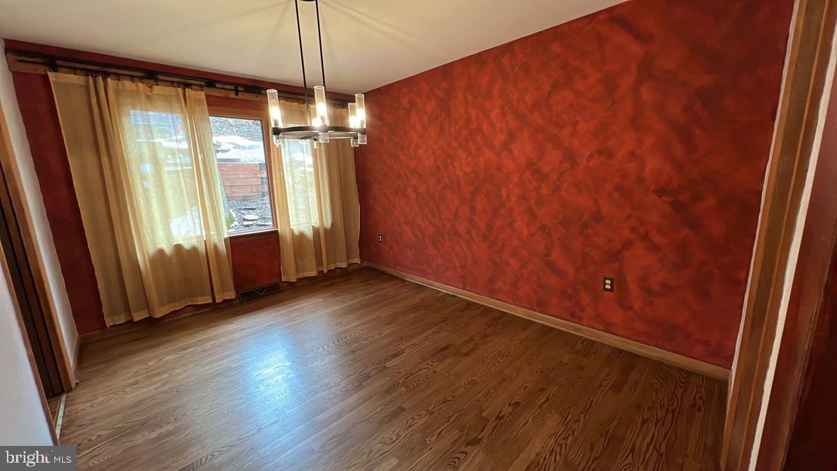 6728 Hemlock Point Road New Market, MD 21774 - Photo 8 of 28 an empty room with wooden floor and windows