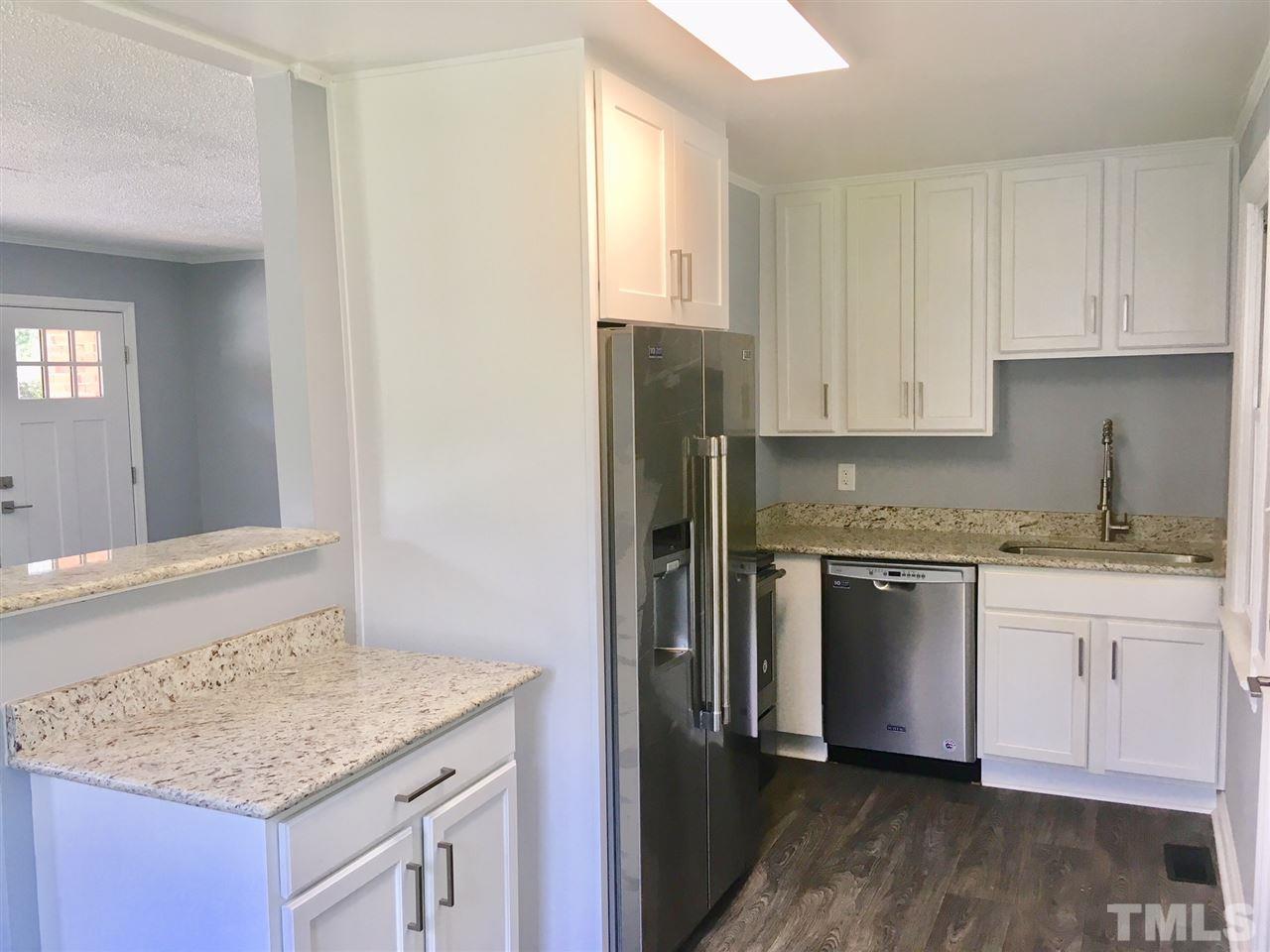 612 Brighton Road Raleigh, NC 27610 - Photo 2 of 16 a kitchen with granite countertop cabinets stainless steel appliances and a counter space