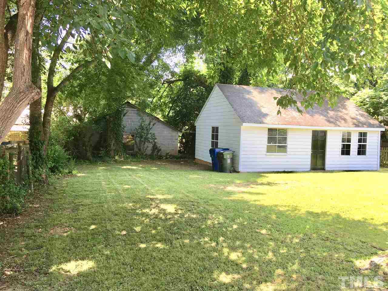 612 Brighton Road Raleigh, NC 27610 - Photo 14 of 16 a view of a house with a backyard and a tree