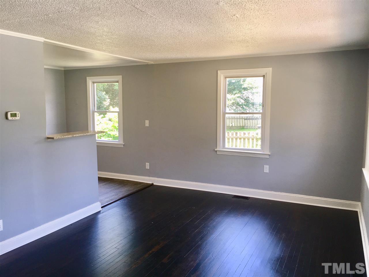 612 Brighton Road Raleigh, NC 27610 - Photo 4 of 16 a view of an empty room with wooden floor and a window