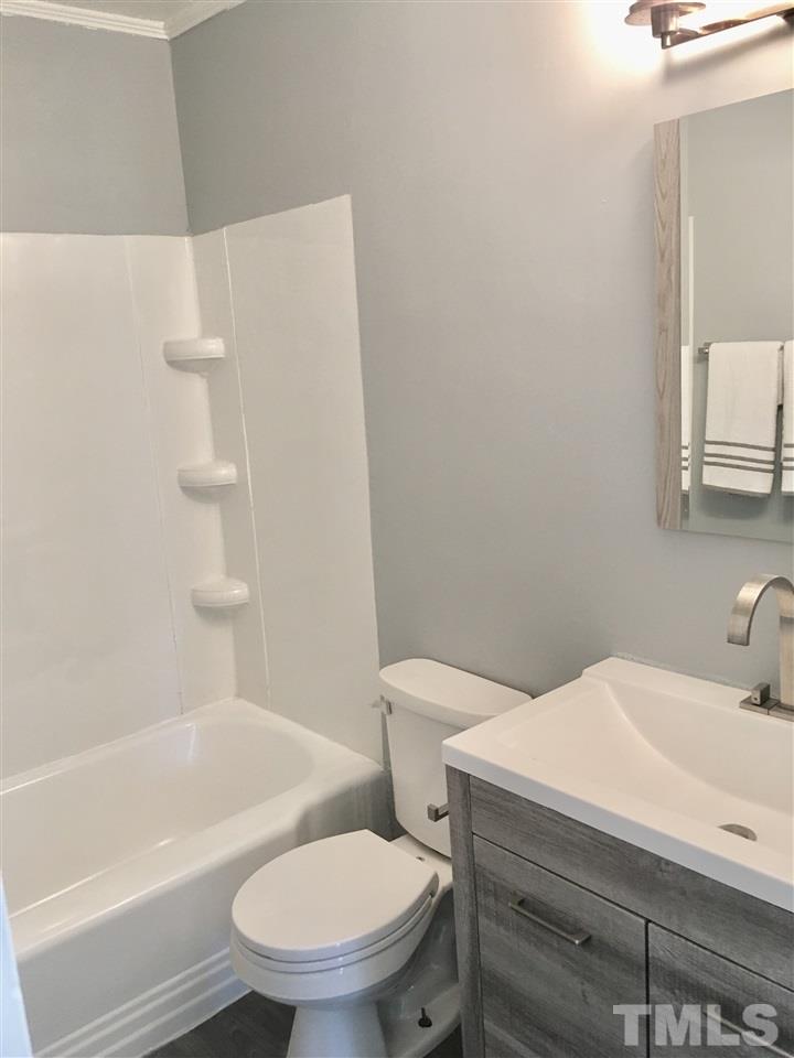 612 Brighton Road Raleigh, NC 27610 - Photo 7 of 16 a bathroom with a sink a toilet and bathtub