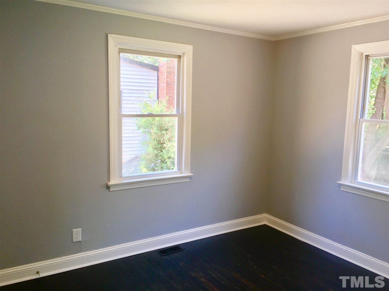 612 Brighton Road Raleigh, NC 27610 - Photo 8 of 16 a view of an empty room with wooden floor and a window
