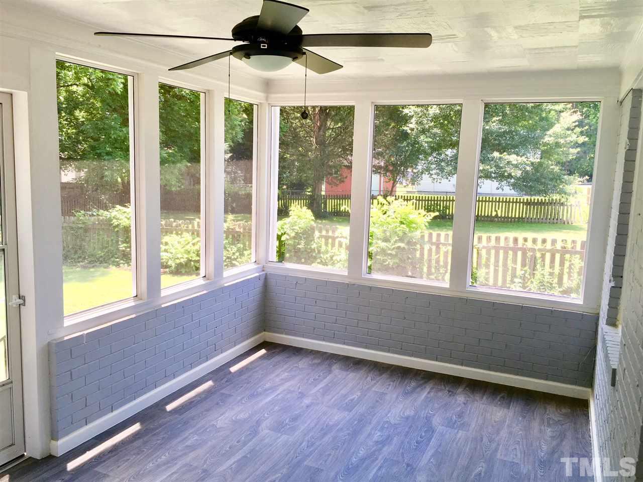 612 Brighton Road Raleigh, NC 27610 - Photo 10 of 16 a view of an empty room with wooden floor and a window