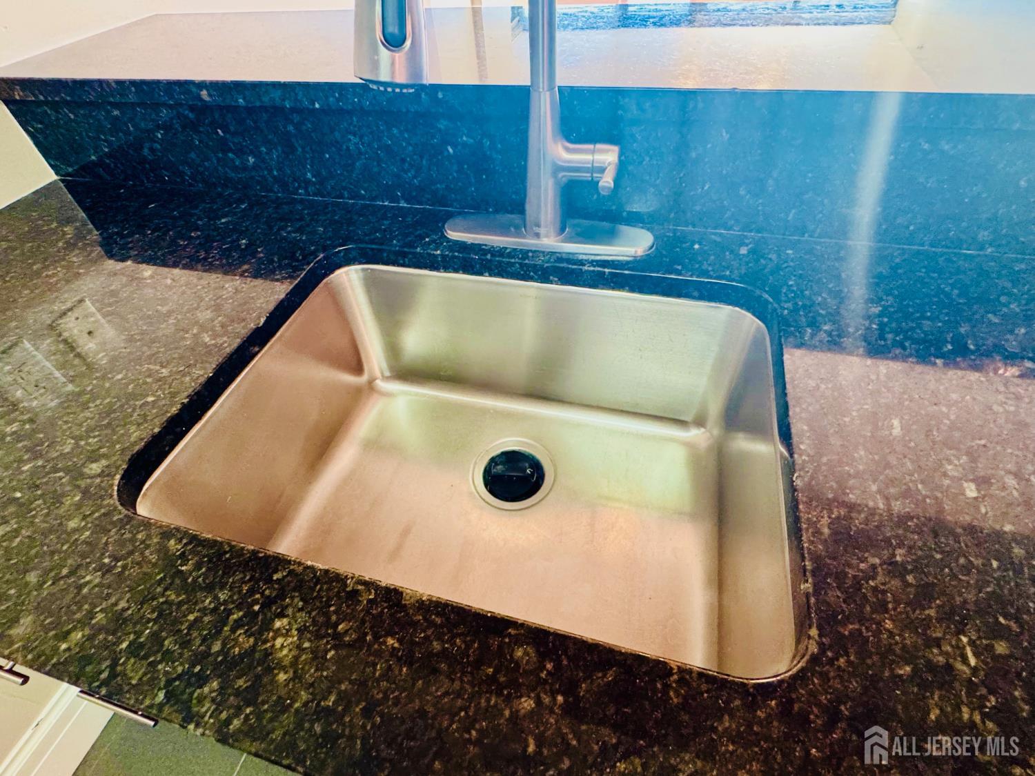 1 Spring Street, Unit 1806 New Brunswick, NJ 08901 - Photo 15 of 65 a bathroom with a granite countertop sink