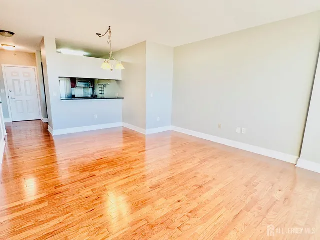a view of a kitchen with wooden floor and a ceiling fan