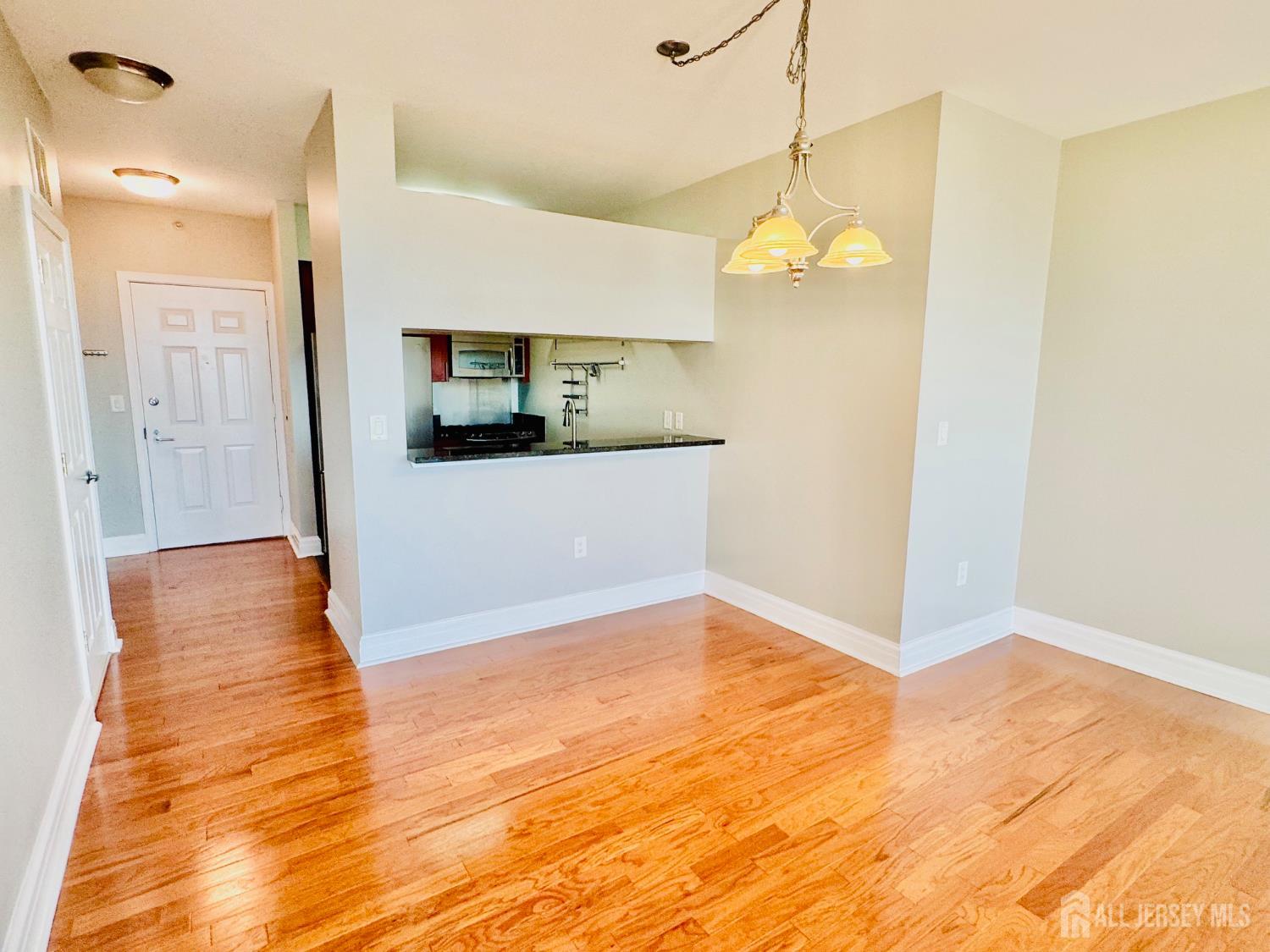 1 Spring Street, Unit 1806 New Brunswick, NJ 08901 - Photo 20 of 65 a view of a kitchen with wooden floor and a ceiling fan