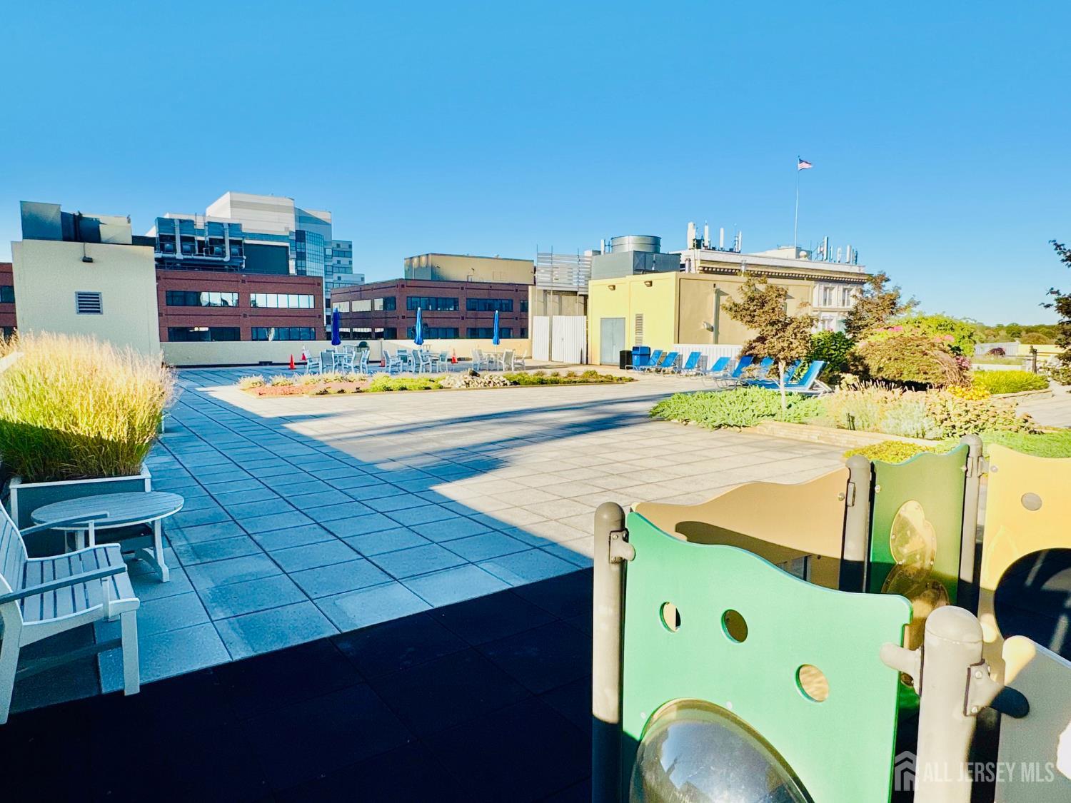 1 Spring Street, Unit 1806 New Brunswick, NJ 08901 - Photo 48 of 65 a view of a swimming pool outdoor seating and yard