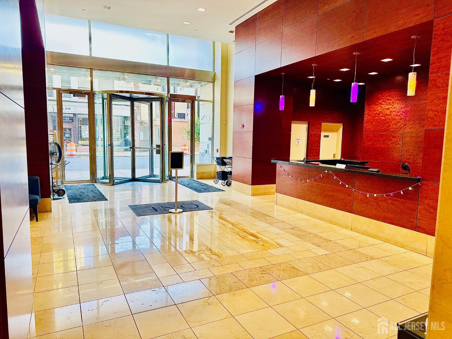 1 Spring Street, Unit 1806 New Brunswick, NJ 08901 - Photo 5 of 65 a lobby with glass door and glass door