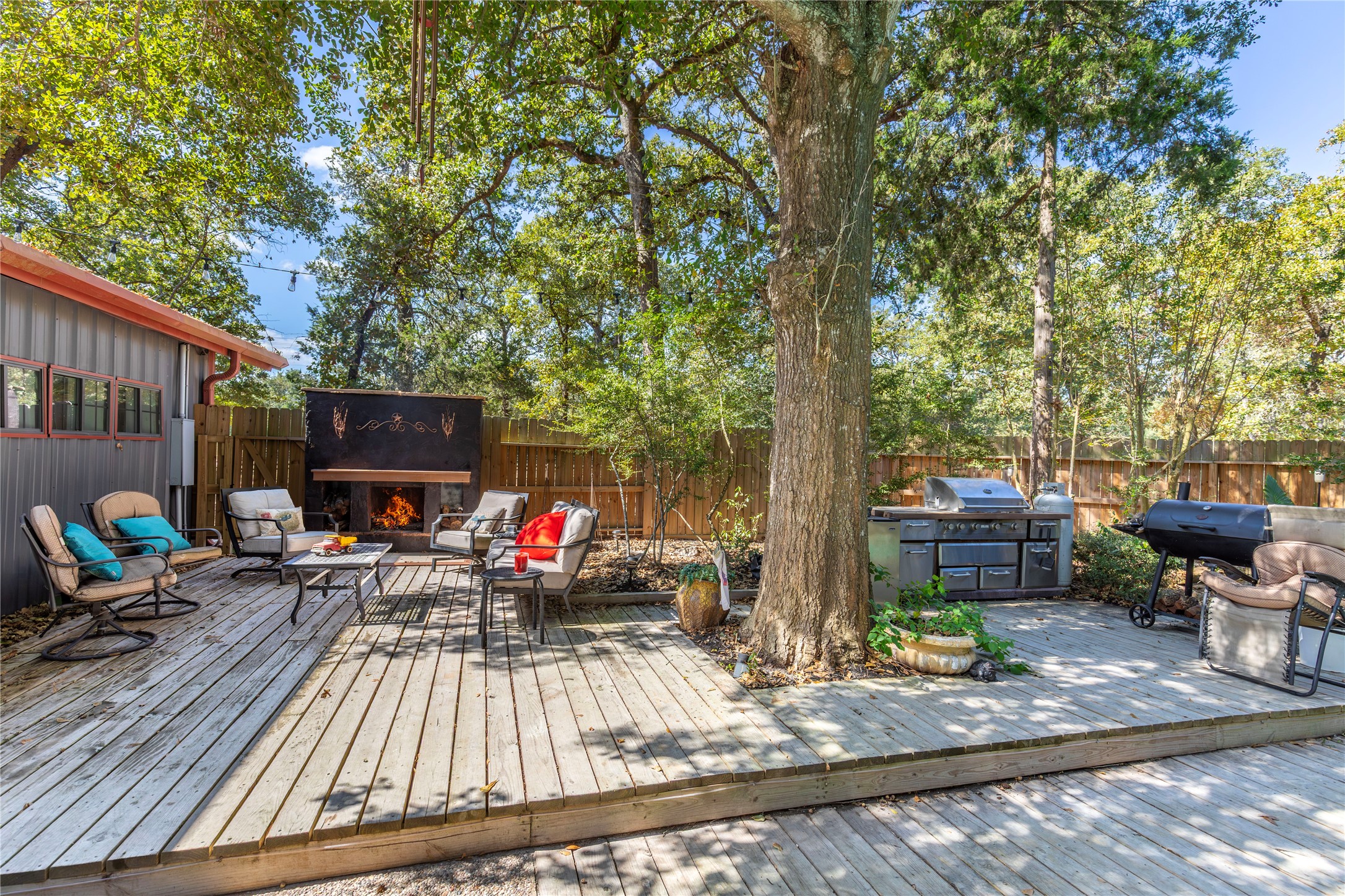 7710 Highway 36 Bellville, TX 77418 - Photo 18 of 25 A deck designed for entertaining, featuring an outdoor kitchen, fireplace, and seating area—all overlooking the pool.