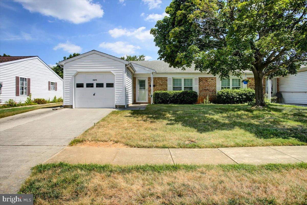 5671 Crabapple Drive Frederick, MD 21703 - Photo 2 of 31 a front view of a house with a yard and garage