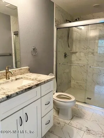 an empty room with wooden floor and mirror